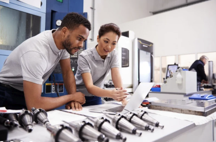 Two engineers looking at laptop