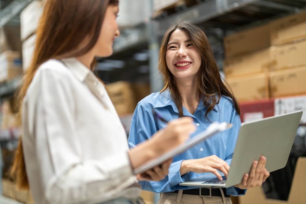 Female engineers team discussing inventory in warehouse logistics and supply chain planning