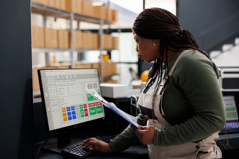 Woman checking inventory on computer